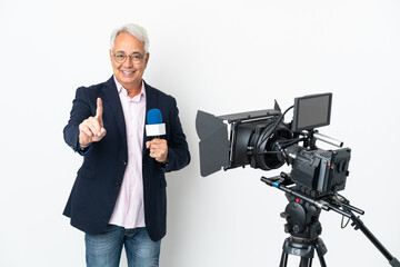 Reporter Middle age Brazilian man holding a microphone and reporting news isolated on white background showing and lifting a finger