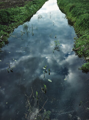 Top view to a flowing water between too lakesides