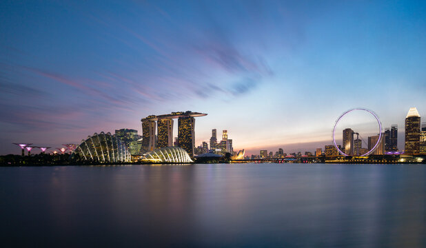 Singapore, Long exposure of Marina Bay at dusk with Marina Bay Sands hotel and Singapore Flyer in background