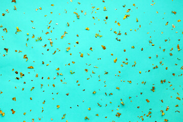 Gold sequins sparkle against a light blue (tiffany) festive backdrop. Background for designers, festive background