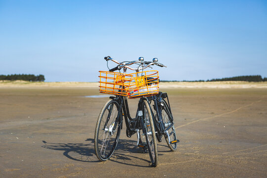 Denmark, Romo, Bicycles left on sandy beach