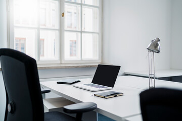 Laptop and dairy on desk at office