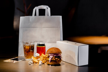 Food and drink arranged by paper bag and box on kitchen island