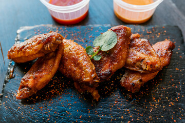 Chicken wings seasoning served on black plate