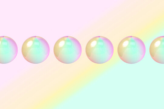 Three dimensional render of row of bubbles against colorful background