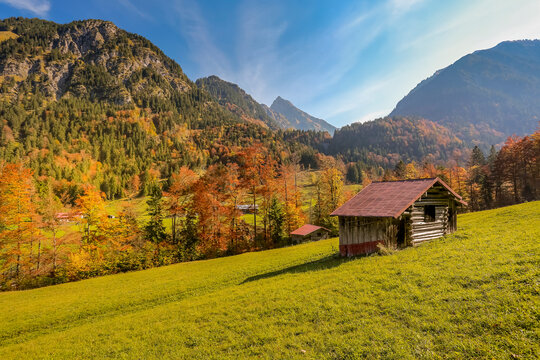 Oytal valley in autumn with small hut in foreground
