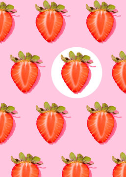 Pattern of rows of fresh halved strawberries lying against pink background