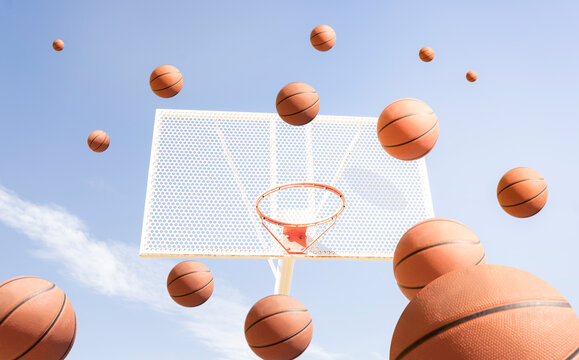 Balls bouncing by basketball hoop