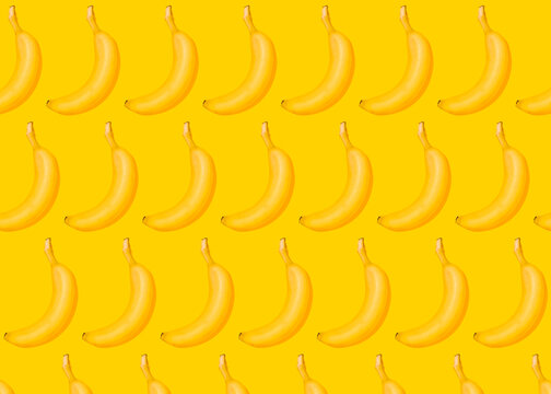 Pattern of rows of bananas lying against yellow background