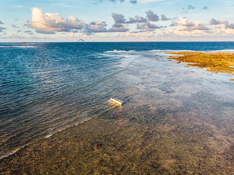 Drone view of coastline of Siargao island with lone kitesurfer in background