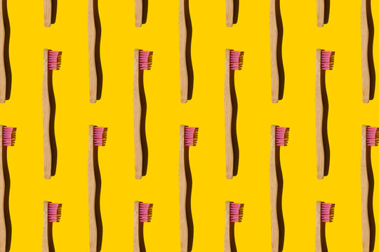 Digitally generated pattern with bamboo toothbrushes on yellow background