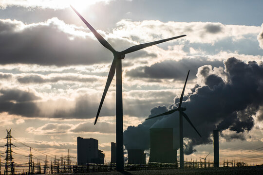 Germany, North Rhine Westphalia, Niederaussem, Wind turbine with lignite power plant in background