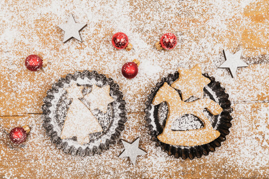 Christmas Ornaments And Fresh Homemade Cookies Lying On Wooden Surface