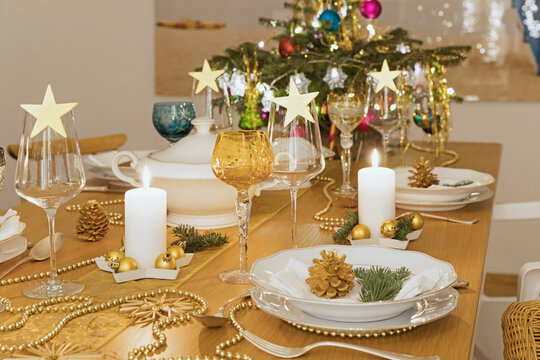 Festive Christmas table with small Christmas tree in background
