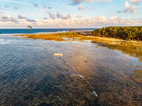 Drone view of coastline of Siargao island with lone kitesurfer in background