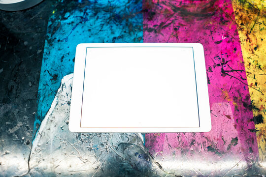 Digital tablet on multi colored scratched table