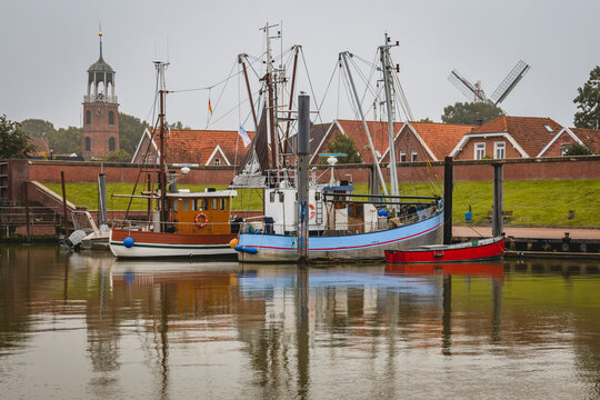 Germany, Lower Saxony, Ditzum, Fishing boats moored in town harbor