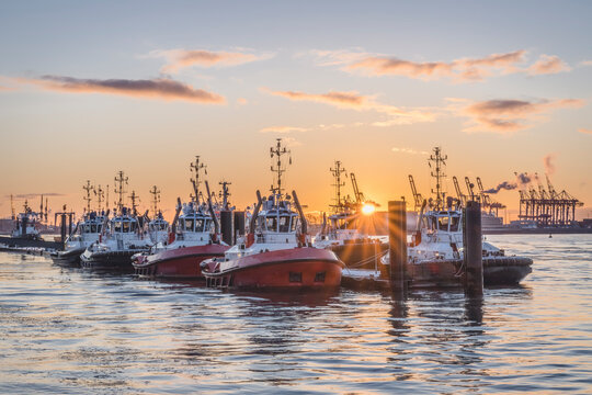 Germany, Hamburg, Boats moored in Neumuhlen at sunset in winter