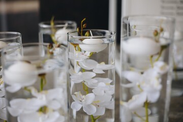 Romantic Wedding Table Top Layout Decor with large lush floral bouquets including white roses, ranunculus, persian buttercups, white orchids and candles