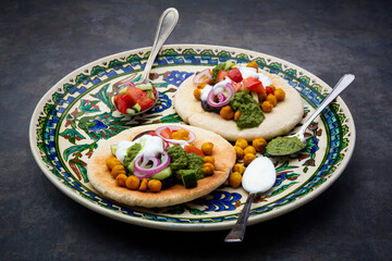 Garnished Sabich, pita bread with fresh vegetables, onions, yogurt and sauce