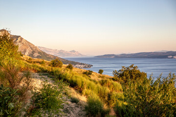 Sunlight over mountains near Adriatic sea in Omis, Dalmatia, Croatia