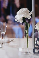 Romantic Wedding Table Top Layout Decor with large lush floral bouquets including white roses, ranunculus, persian buttercups, white orchids and candles