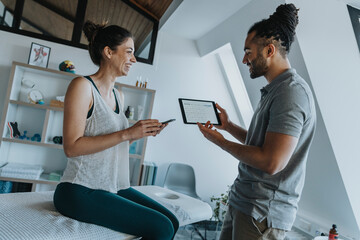 Smiling female patient with physiotherapist in medical practice