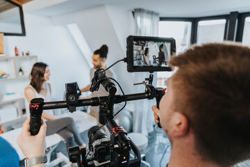 Male physiotherapist and female patient being filmed by videographer in practice