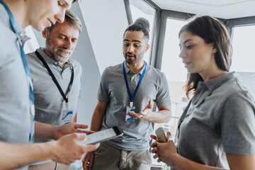 Male professional discussing over digital tablet with colleagues during conference