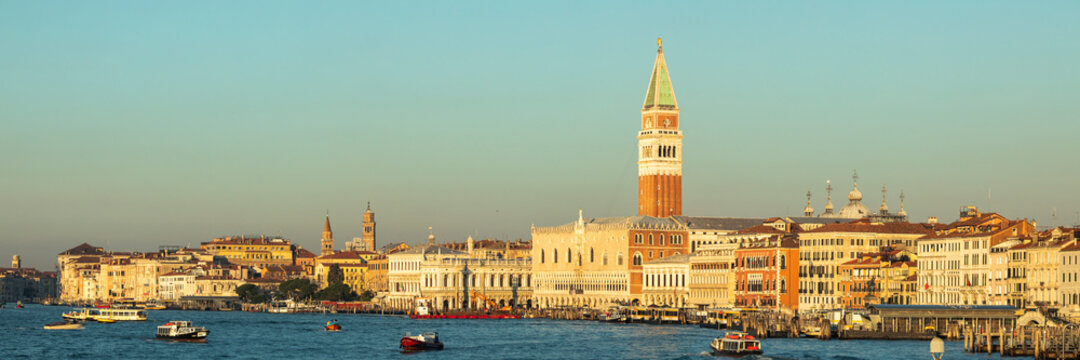 Italy, Veneto, Venice, Panorama of Grand Canal at dusk with waterfront houses and Saint Marks Campanile in background