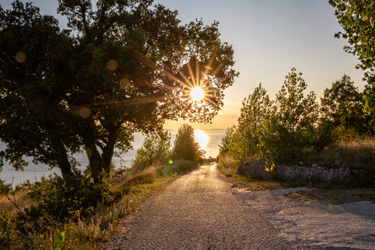 Empty road with sunset over Adriatic sea in Omis, Dalmatia, Croatia