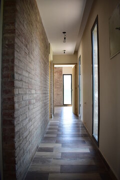 Brick Wall on a Traditional System Construction Home Building with Vertical Windows