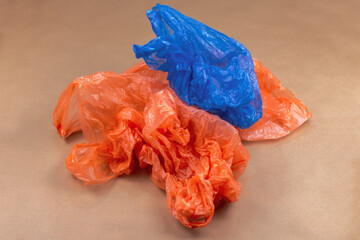 Studio shot of blue and orange plastic bags