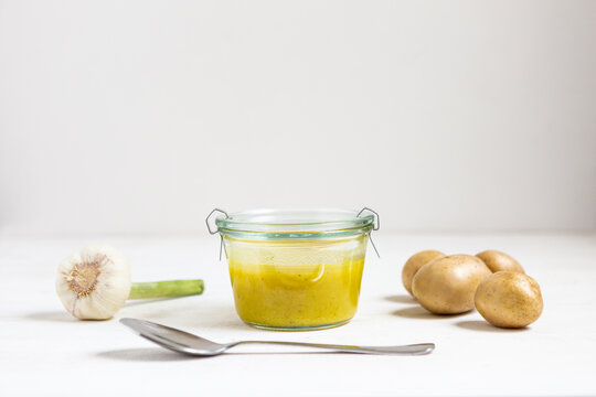 Soup by vegetables and spoon on white background