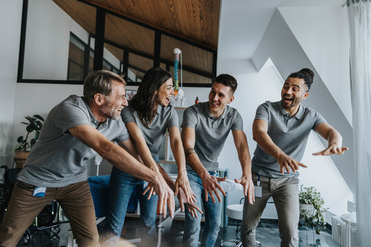 Physiotherapists laughing while doing La Ola Wave in practice