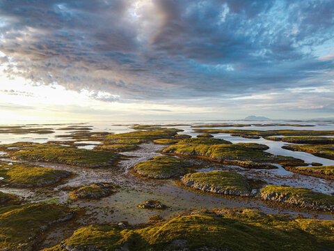 Norway, Vega Archipelago, Aerial of the rugged coastline of Unesco world heritage site at sunset