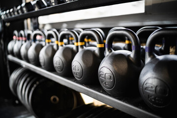 Row of kettlebells on gym rack