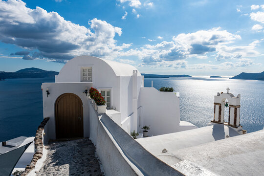 Greece, Santorini, Oia, Whitewashed architecture over blue sea