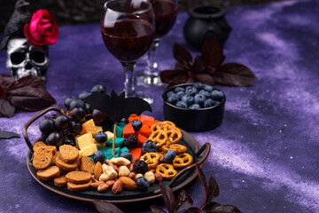 Halloween appetizers. Cheese plate with snacks
