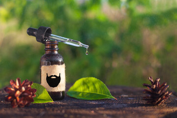 Natural beard oil, brown bottle. Cosmetic for beard or aromatherapy in glass bottle. Copy space....