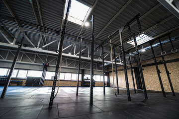 Gymnastic rings and ropes hanging in empty gym