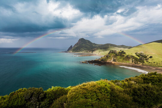 Rainbow arching against storm clouds gathering over coastline of&nbsp;Coromandel&nbsp;Peninsula