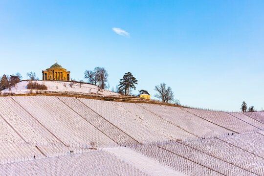 Germany, Baden-Wurttemberg, Stuttgart, Bare snow-covered vineyard with Wurttemberg Mausoleum in background