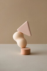 Abstract balancing geometric composition with makeup sponges on pastel beige background with soft shadows. MInimal art with copy space.