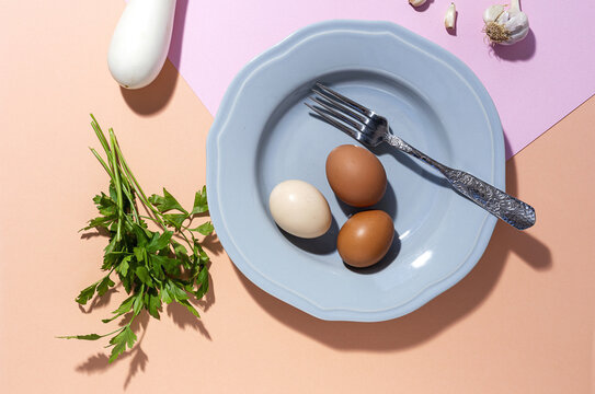Eggs on plate against garlic and white eggplant