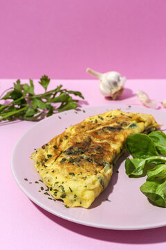 Delicious omelet with fresh spinach leaves and chopped parsley