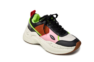 Close-up front view of the sneaker. Bright colors green, pink, black, brown. Shoes for sports. Isolated sneaker on a solid background. White background.