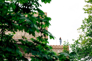 Woman with tablet on building terrace near railing