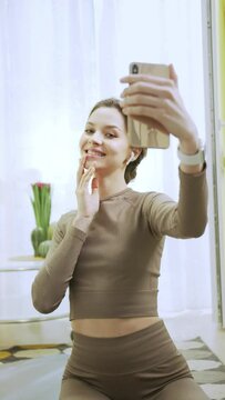 A beautiful woman is posing and taking a photo