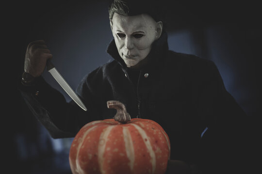 NEW YORK, USA - JUNE 17 2021: Halloween slasher Michael Myers carving a pumpkin - Trick or Treat Studios Action Figure